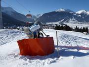 Cannone da neve mobile presso la discesa per famiglie